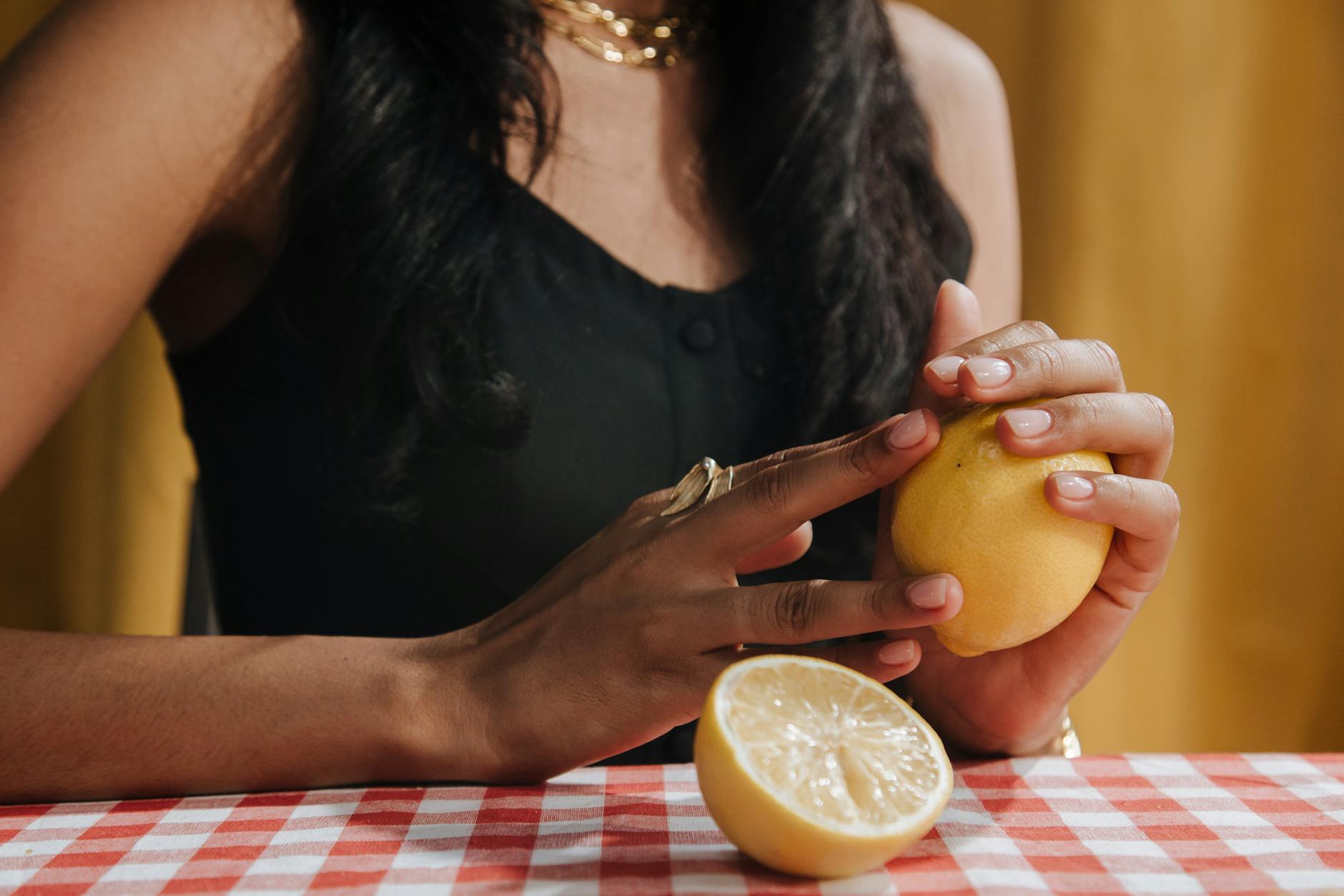 Close-up of hands holding a fresh lemon, symbolizing the awakening of sensation and renewal
