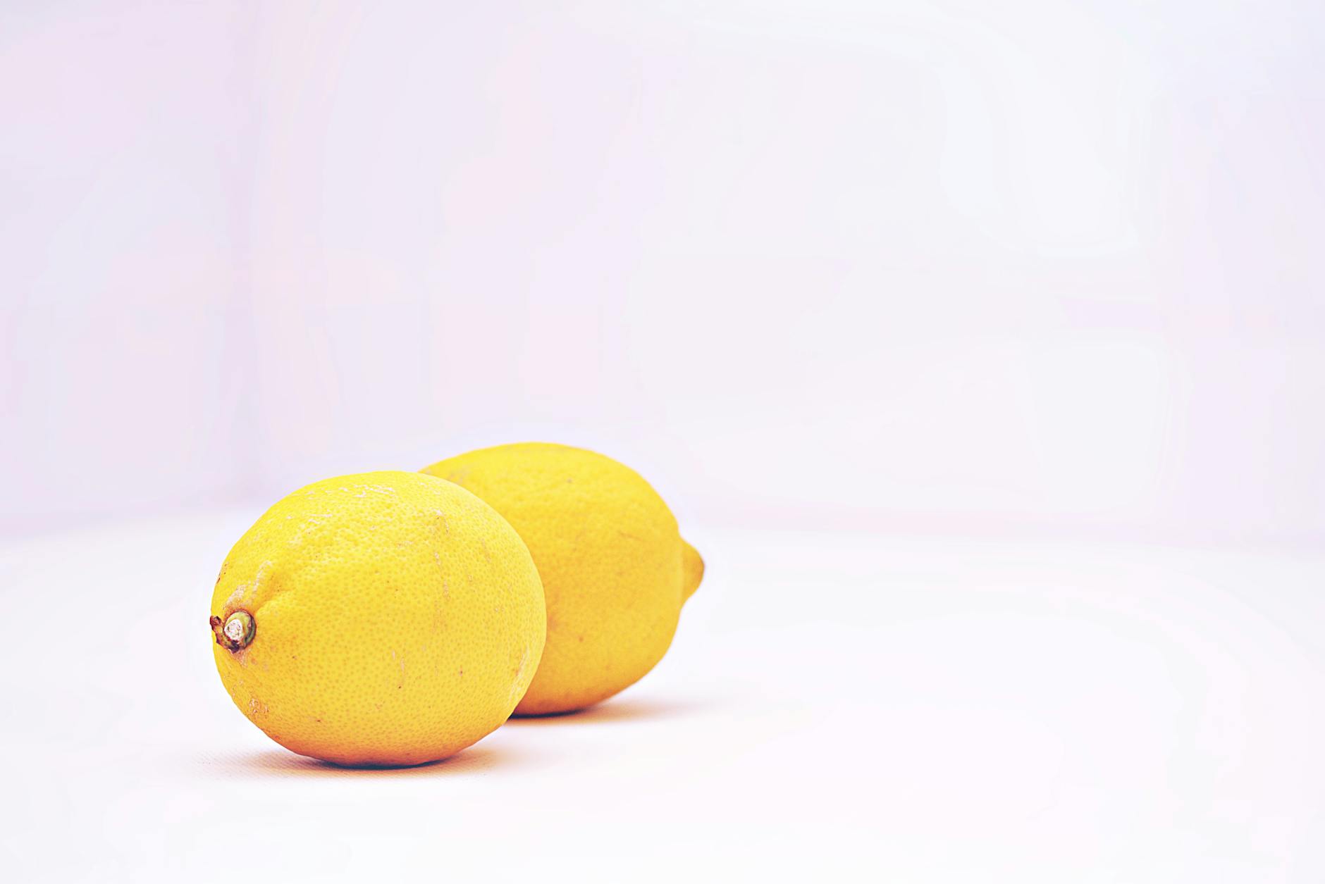 Vibrant lemons on a white background, representing the fresh sensation of lemon vibrator stimulation